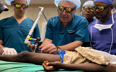 Israel’s Dr Josef Haik teaching Haitian surgeon Dr. Jerry Bernard how to use the laser machine, Milot, Haiti, January 2020. (Courtesy of Burn Advocates Network)