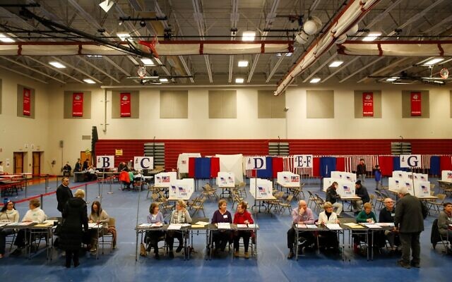 Poll workers wait for voters to check in at Bedford High School during the New Hampshire primary on February 11, 2020 in Bedford, New Hampshire. (Matthew Cavanaugh/Getty Images/AFP) Poll workers wait for voters to check in at Bedford High School during the New Hampshire primary on February 11, 2020 in Bedford, New Hampshire. (Matthew Cavanaugh/Getty Images/AFP)