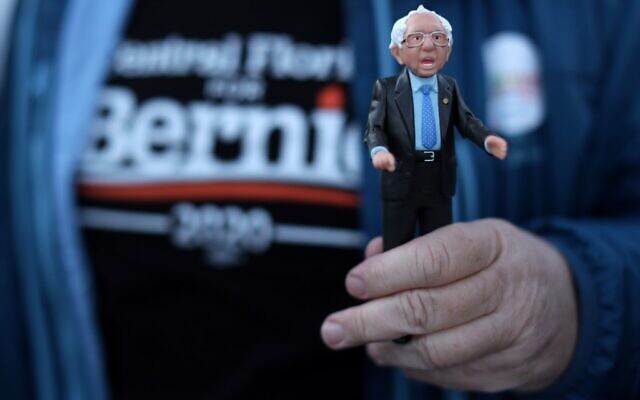 A supporter holds a Bernie Sanders action figure outside a campaign event for Democratic presidential candidate Sen. Bernie Sanders (Vermont independent) at Ingersoll Tap in Des Moines, Iowa on February 2, 2020. (Alex Wong/Getty Images/AFP) A supporter holds a Bernie Sanders action figure outside a campaign event for Democratic presidential candidate Sen. Bernie Sanders (Vermont independent) at Ingersoll Tap in Des Moines, Iowa on February 2, 2020. (Alex Wong/Getty Images/AFP)