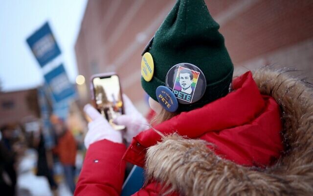 A supporter of Democratic presidential candidate Pete Buttigieg awaits the arrival of Buttigieg outside a polling station at Hopkinton High School on February 11, 2020 in Hopkinton, New Hampshire. (Win McNamee/Getty Images/AFP) A supporter of Democratic presidential candidate Pete Buttigieg awaits the arrival of Buttigieg outside a polling station at Hopkinton High School on February 11, 2020 in Hopkinton, New Hampshire. (Win McNamee/Getty Images/AFP)
