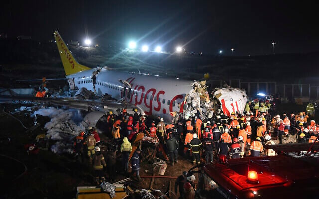 Rescue members and firefighters work around the wreckage of a plane after it skidded off the runway at Istanbul's Sabiha Gokcen Airport, in Istanbul, Wednesday, Feb. 5, 2020. A plane skidded off the runway Wednesday at Istanbul’s Sabiha Gokcen Airport, crashing into a field and breaking into pieces. Passengers were seen evacuating through cracks in the plane and authorities said dozens have been injured. (Ismail Coskun/IHA via AP) Rescue members and firefighters work around the wreckage of a plane after it skidded off the runway at Istanbul's Sabiha Gokcen Airport, in Istanbul, Wednesday, Feb. 5, 2020. A plane skidded off the runway Wednesday at Istanbul’s Sabiha Gokcen Airport, crashing into a field and breaking into pieces. Passengers were seen evacuating through cracks in the plane and authorities said dozens have been injured. (Ismail Coskun/IHA via AP)