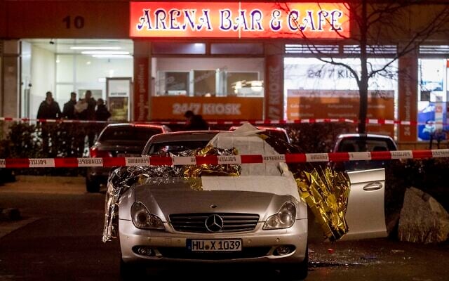 A car with covered dead bodies stands in front of a bar in Hanua, Germany Thursday, Feb. 20, 2020. German police say several people were shot to death in the city of Hanau on Wednesday evening. (AP Photo/Michael Probst) A car with covered dead bodies stands in front of a bar in Hanua, Germany Thursday, Feb. 20, 2020. German police say several people were shot to death in the city of Hanau on Wednesday evening. (AP Photo/Michael Probst)