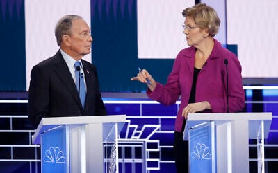Democratic presidential candidates, former New York City Mayor Mike Bloomberg, left, and Sen. Elizabeth Warren, D-Mass., talk before a Democratic presidential primary debate Wednesday, Feb. 19, 2020, in Las Vegas, hosted by NBC News and MSNBC. (AP Photo/John Locher)