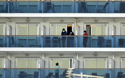 Passengers speak on balconies of the quarantined Diamond Princess cruise ship docked at a port in Yokohama, near Tokyo, February 20, 2020. (Eugene Hoshiko/AP)