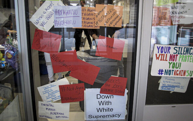 This Nov. 21, 2019 file photo shows signs posted on windows and doors at Syracuse University displaying anti-racism expressions in Syracuse, NY (AP Photo/Carolyn Thompson, File) This Nov. 21, 2019 file photo shows signs posted on windows and doors at Syracuse University displaying anti-racism expressions in Syracuse, NY (AP Photo/Carolyn Thompson, File)