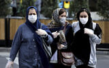 People wear masks to help guard against the Coronavirus on a street in downtown Tehran, Iran, February 23, 2020. (Ebrahim Noroozi/AP)