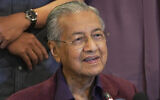 In this February 22, 2020, file photo, Malaysian Prime Minister Mahathir Mohamad speaks during a press conference in Putrajaya, Malaysia. (AP Photo/Vincent Thian)