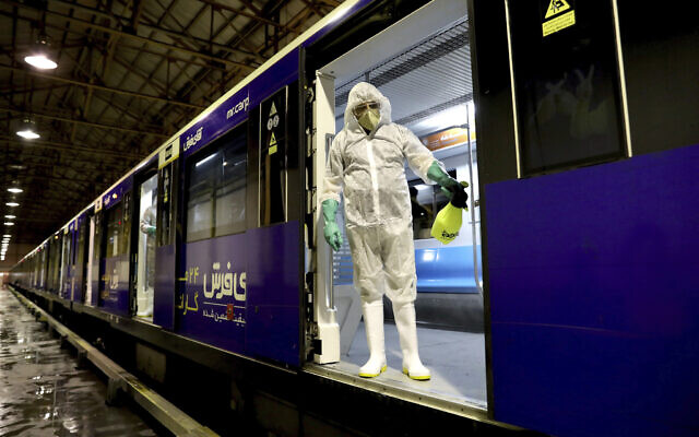 A worker disinfects subway trains against coronavirus in Tehran, Iran, in the early morning of February 26, 2020. (AP Photo/Ebrahim Noroozi)