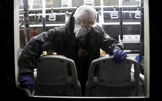 A worker disinfects a public bus against coronavirus in Tehran, Iran, in early morning of Wednesday, February 26, 2020. (AP Photo/Ebrahim Noroozi) A worker disinfects a public bus against coronavirus in Tehran, Iran, in early morning of Wednesday, February 26, 2020. (AP Photo/Ebrahim Noroozi)