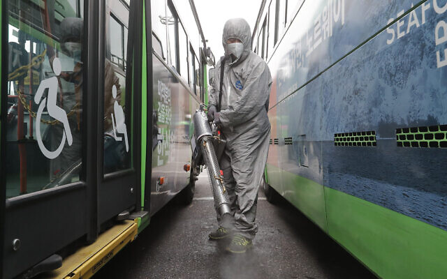A worker wearing a protective suit sprays disinfectant as a precaution against the coronavirus at a bus garage in Seoul, South Korea, Wednesday, Feb. 26, 2020. (AP Photo/Ahn Young-joon) A worker wearing a protective suit sprays disinfectant as a precaution against the coronavirus at a bus garage in Seoul, South Korea, Wednesday, Feb. 26, 2020. (AP Photo/Ahn Young-joon)