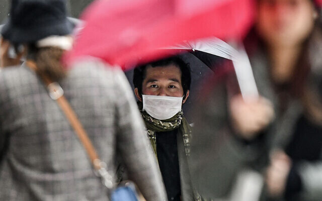 A man wears a face mask on a pedestrian street in Duesseldorf, Germany, Wednesday, Feb. 26, 2020. (AP Photo/Martin Meissner) A man wears a face mask on a pedestrian street in Duesseldorf, Germany, Wednesday, Feb. 26, 2020. (AP Photo/Martin Meissner)