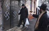 Illustrative: In this March 2, 2007 file photo, head of the Jewish community Gennady Klebanov, left, is about to enter the swastika-smeared door of the synagogue, as chief rabbi of Vladivostok Isroel Silberstain, right, points in the Russian Far Eastern Port of Vladivostok. (AP)