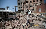 A man inspects rubble after a Saudi-led coalition airstrike in Sanaa, Yemen, February 4, 2018. (Hani Mohammed/AP)