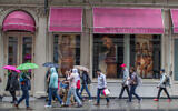 Shoppers walk past the Victoria's Secret store on Broadway in the Soho neighborhood of New York, on April 4, 2018. (AP Photo/Mary Altaffer, File)