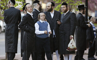 Illustrative image: Ultra-Orthodox Jews stand outside the New Jersey Center for the Performing Arts (NJPAC) while waiting for the start of a Yiddish performance, April 24, 2019, in Newark, New Jersey. (AP Photo/Kathy Willens)
