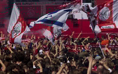 Ajax fans wait for the players to arrive with the trophy when celebrating clinching the Dutch Premier League title in Amsterdam, Netherlands, Thursday, May 16, 2019. (AP/Peter Dejong)
