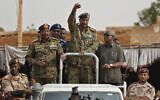 Sudanese Gen. Abdel-Fattah al-Burhan, head of the military council, waves to his supporters upon arriving to attend a military-backed rally, in Omdurman district, west of Khartoum, Sudan, June 29, 2019. (AP Photo/Hussein Malla)
