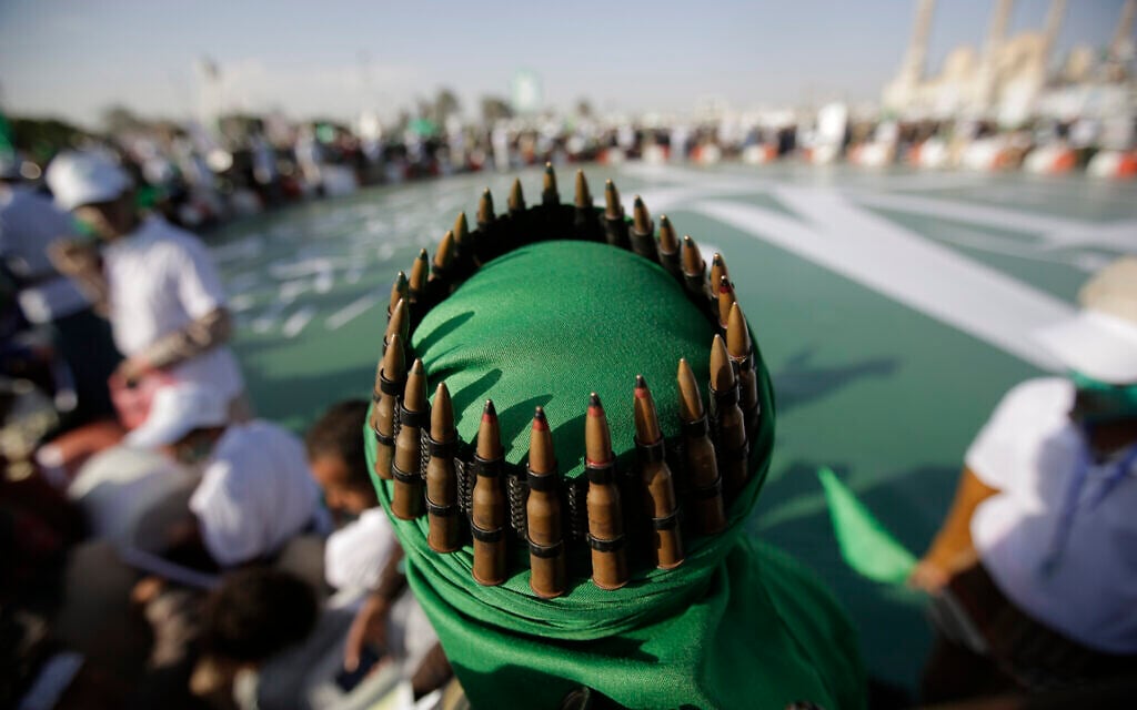 A supporter of the Shiite Houthi rebels with an ammunition belt placed on his head attends a celebration in Sanaa, Yemen, November 9, 2019. (Hani Mohammed/AP) A supporter of the Shiite Houthi rebels with an ammunition belt placed on his head attends a celebration in Sanaa, Yemen, November 9, 2019. (Hani Mohammed/AP)