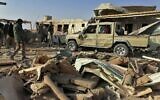 Fighters from the Kataeb Hezbollah, or Hezbollah Brigades militia, inspect the destruction at their headquarters in the aftermath of a US airstrike in Qaim, Iraq, December 30, 2019. (AP)