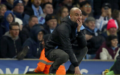 Manchester City's head coach Pep Guardiola reacts after a missed chance to score during the English League Cup semifinal second leg soccer match between Manchester City and Manchester United at Etihad stadium in Manchester, England, Wednesday, Jan. 29, 2020. (AP Photo/Dave Thompson)