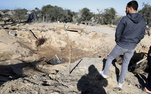 A resident inspects a crater following overnight Israeli missile strikes, in Rafah, southern Gaza Strip, Friday, Jan. 31, 2020.  (AP/Adel Hana)