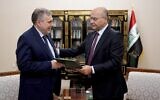 Iraqi President Barham Salih, right, instructs newly appointed Prime Minister Mohammed Allawi in Baghdad, Iraq, Saturday, Feb. 1, 2020. (Iraqi Presidency Media Office, via AP)