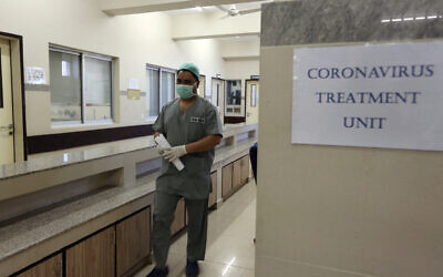 A Pakistan doctor enters an isolation ward set up as a preventative measure following the deadly Coronavirus outbreak, at the Jinnah Postgraduate Medical Center in Karachi, Pakistan, February 3, 2020. (Fareed Khan/AP)