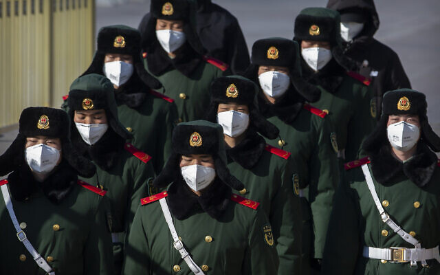 Paramilitary policemen wear face masks as they march in formation into a pedestrian underpass next to Tiananmen Square in Beijing, February 4, 2020. (Mark Schiefelbein/AP) Paramilitary policemen wear face masks as they march in formation into a pedestrian underpass next to Tiananmen Square in Beijing, February 4, 2020. (Mark Schiefelbein/AP)