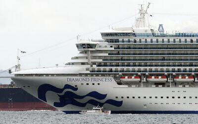 A small boat navigates near the cruise ship Diamond Princess anchoring off the Yokohama Port, in Yokohama, near Tokyo, Japan, February 4, 2020.(Eugene Hoshiko/AP)