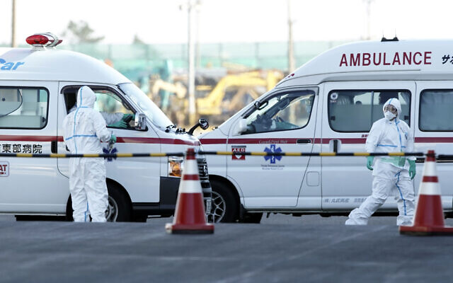Officials in protective suits prepare near the cruise ship Diamond Princess anchored at Yokohama Port in Yokohama, south of Tokyo, February 6, 2020. (AP Photo/Eugene Hoshiko) Officials in protective suits prepare near the cruise ship Diamond Princess anchored at Yokohama Port in Yokohama, south of Tokyo, February 6, 2020. (AP Photo/Eugene Hoshiko)