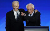 Former US vice president Joe Biden, left, embraces Sen. Bernie Sanders during a Democratic presidential primary debate, February 7, 2020, hosted by ABC News, Apple News, and WMUR-TV at Saint Anselm College in Manchester, New Hampshire. (AP Photo/Elise Amendola)