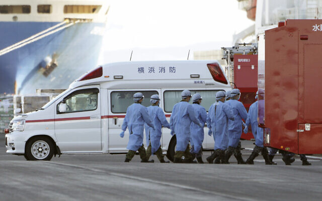 Members of Japan Self Defense Forces walk into the quarantined cruise ship Diamond Princess in the Yokohama Port, Feb. 9, 2020, in Yokohama, Japan (AP Photo/Eugene Hoshiko) Members of Japan Self Defense Forces walk into the quarantined cruise ship Diamond Princess in the Yokohama Port, Feb. 9, 2020, in Yokohama, Japan (AP Photo/Eugene Hoshiko)