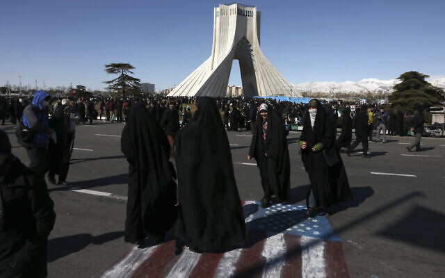 Demonstrators walk on a painting of the US flag in front of the Azadi (Freedom) tower during an annual rally celebrating 41st anniversary of Islamic Revolution, in Tehran, Iran, Feb. 11, 2020 (AP Photo/Vahid Salemi) Demonstrators walk on a painting of the US flag in front of the Azadi (Freedom) tower during an annual rally celebrating 41st anniversary of Islamic Revolution, in Tehran, Iran, Feb. 11, 2020 (AP Photo/Vahid Salemi)