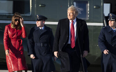 US President Donald Trump walks to Air Force One with first lady Melania Trump as he departs at Andrews Air Force Base, Maryland, February 14, 2020. (Alex Brandon/AP)