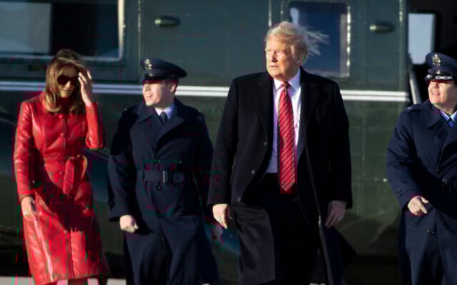 US President Donald Trump walks to Air Force One with first lady Melania Trump as he departs at Andrews Air Force Base, Maryland, February 14, 2020. (Alex Brandon/AP) US President Donald Trump walks to Air Force One with first lady Melania Trump as he departs at Andrews Air Force Base, Maryland, February 14, 2020. (Alex Brandon/AP)