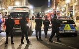 Police stand guard near the scene of a shooting in central Hanau, Germany Thursday, Feb. 20, 2020. German police say several people were shot to death in the city of Hanau on Wednesday evening. (AP Photo/Michael Probst)