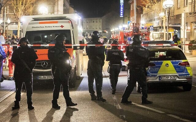 Police stand guard near the scene of a shooting in central Hanau, Germany Thursday, Feb. 20, 2020. German police say several people were shot to death in the city of Hanau on Wednesday evening. (AP Photo/Michael Probst) Police stand guard near the scene of a shooting in central Hanau, Germany Thursday, Feb. 20, 2020. German police say several people were shot to death in the city of Hanau on Wednesday evening. (AP Photo/Michael Probst)