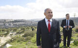 Prime Minister Benjamin Netanyahu stands at an overview overlooking the East Jerusalem neighborhood of Har Homa, where he announced a new neighborhood is to be built, February 20, 2020. (Debbie Hill/Pool via AP)