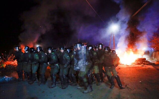 Ukrainian riot police prepare to push back protesters, who planned to stop buses carrying passengers evacuated from the Chinese city of Wuhan, outside Novi Sarzhany, Ukraine, Feb. 20, 2020. (AP/Efrem Lukatsky) Ukrainian riot police prepare to push back protesters, who planned to stop buses carrying passengers evacuated from the Chinese city of Wuhan, outside Novi Sarzhany, Ukraine, Feb. 20, 2020. (AP/Efrem Lukatsky)