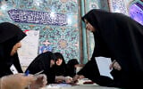 A voter registers to cast her vote during the parliament elections at a polling station in Tehran, Iran, February 21, 2020. (AP Photo/Ebrahim Noroozi)