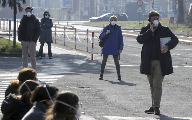 Workers wear masks at the Unilever factory where a 38-year-old working in the research and development branch fall ill with the new virus from China, in Casalpusterlengo, Northern Italy, Saturday, Feb. 22, 2020. (AP/Luca Bruno) Workers wear masks at the Unilever factory where a 38-year-old working in the research and development branch fall ill with the new virus from China, in Casalpusterlengo, Northern Italy, Saturday, Feb. 22, 2020. (AP/Luca Bruno)