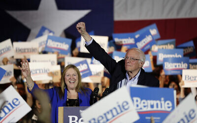 Democratic presidential candidate Sen. Bernie Sanders, I-Vt., right, with his wife Jane, raises his hand as he speaks during a campaign event in San Antonio, Saturday, Feb. 22, 2020. (AP/Eric Gay)