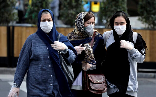 People wear masks to help guard against the Coronavirus on a street in downtown Tehran, Iran, Sunday, Feb. 23, 2020. (AP/Ebrahim Noroozi) People wear masks to help guard against the Coronavirus on a street in downtown Tehran, Iran, Sunday, Feb. 23, 2020. (AP/Ebrahim Noroozi)