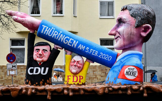 A carnival float depicts far-right AfD politician Bjoern Hoecke, whose arm is raised by CDU politician Mike Mohring and FDP politician Thomas Kemmerich at the Thuringa elections, seen prior the traditional carnival parade in Duesseldorf, Germany, on Feb. 24, 2020. (AP Photo/Martin Meissner) A carnival float depicts far-right AfD politician Bjoern Hoecke, whose arm is raised by CDU politician Mike Mohring and FDP politician Thomas Kemmerich at the Thuringa elections, seen prior the traditional carnival parade in Duesseldorf, Germany, on Feb. 24, 2020. (AP Photo/Martin Meissner)