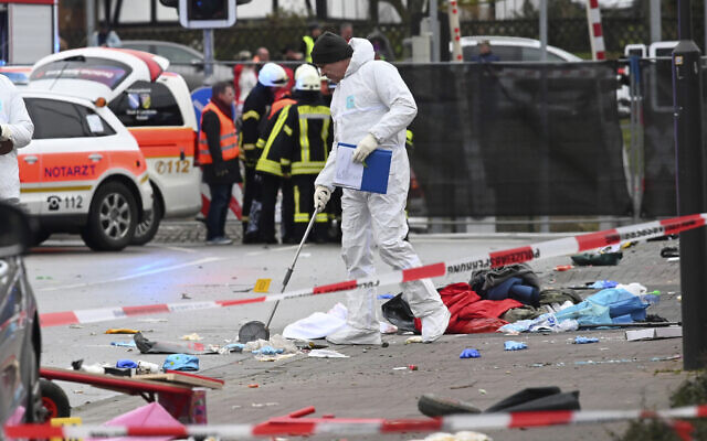 Police and rescue workers stand next to where a car crashed into a carnival parade in Volkmarsen, central Germany, February 24, 2020 (Uwe Zucchi/dpa via AP) Police and rescue workers stand next to where a car crashed into a carnival parade in Volkmarsen, central Germany, February 24, 2020 (Uwe Zucchi/dpa via AP)