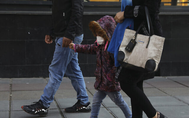 A child wears a mask while walking with parents in downtown Tehran, Iran, Feb. 27, 2020 (AP Photo/Vahid Salemi) A child wears a mask while walking with parents in downtown Tehran, Iran, Feb. 27, 2020 (AP Photo/Vahid Salemi)
