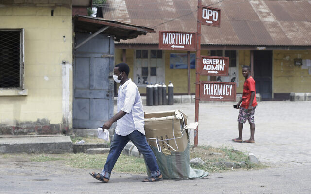 A man wearing face mask walks at the Yaba Mainland hospital where the first Nigerian victims of the COVID-19 virus are being treated in Lagos, Nigeria, Feb. 28, 2020 (Sunday Alamba via AP)