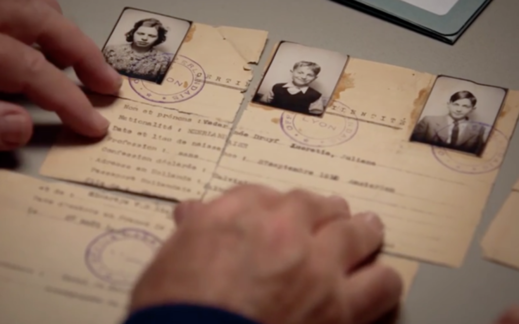 Lady Irene Hatter and brother Jacques Noach examining the fake identity documents which saved Herman Veder's family in a scene from 'Forgotten Soldier' (Courtesy: Road on the Show Productions Ltd)