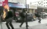 Screen capture from video of a border police engulfed in flames after he was hit by a Molotov cocktail thrown by a Palestinian rioter in the West Bank city of Hebron, February 3, 2020. (Twitter)