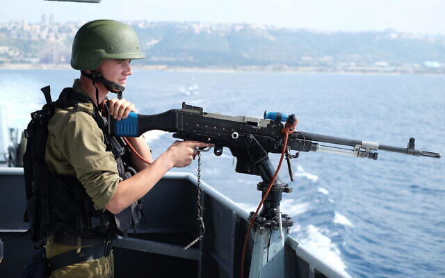 An Israeli sailor prepares to fire a machine gun during a naval exercise off the coast of the northern Israeli city of Haifa on February 3, 2020. (Judah Ari Gross/Times of Israel)
